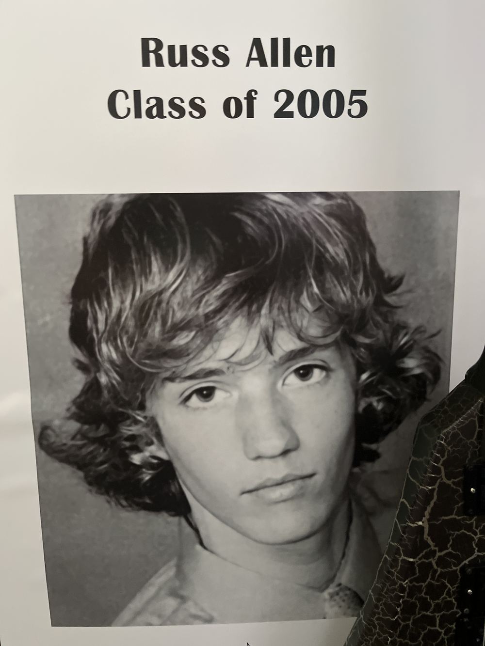 Yearbook photo captioned Russ Allen, Class of 2005, showing a teenager with long wavy hair.