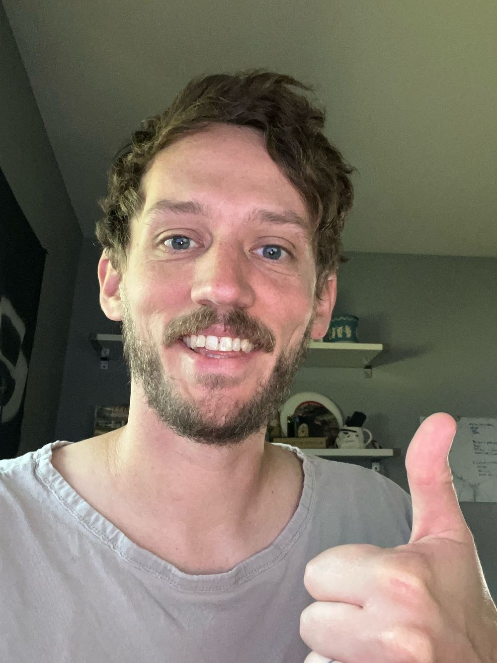 Russ Allen, founder of Unvertise, smiling and giving a thumbs up at home in Louisville, Kentucky.
